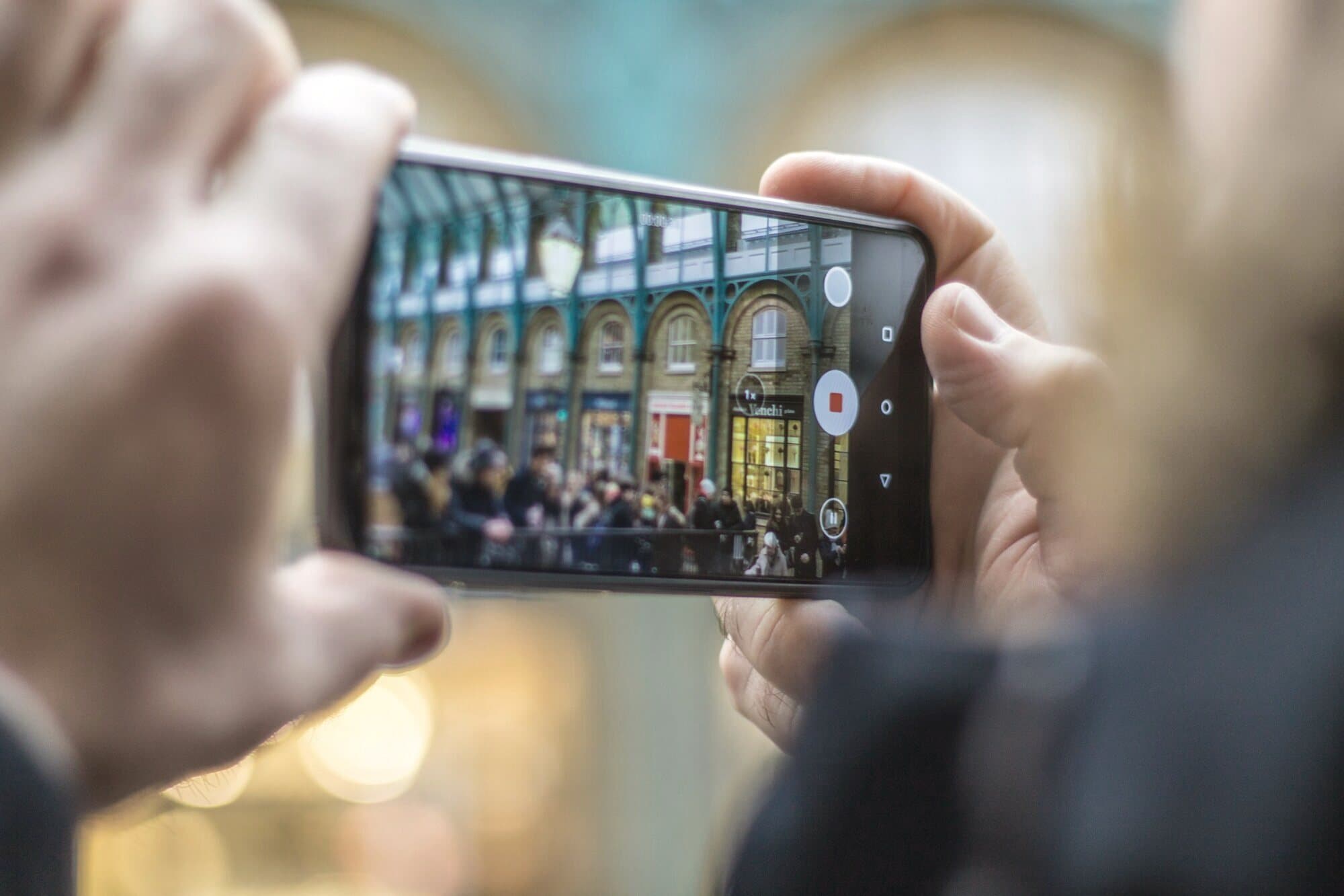 A buyer filming a London shopping street live on a phone during a video call