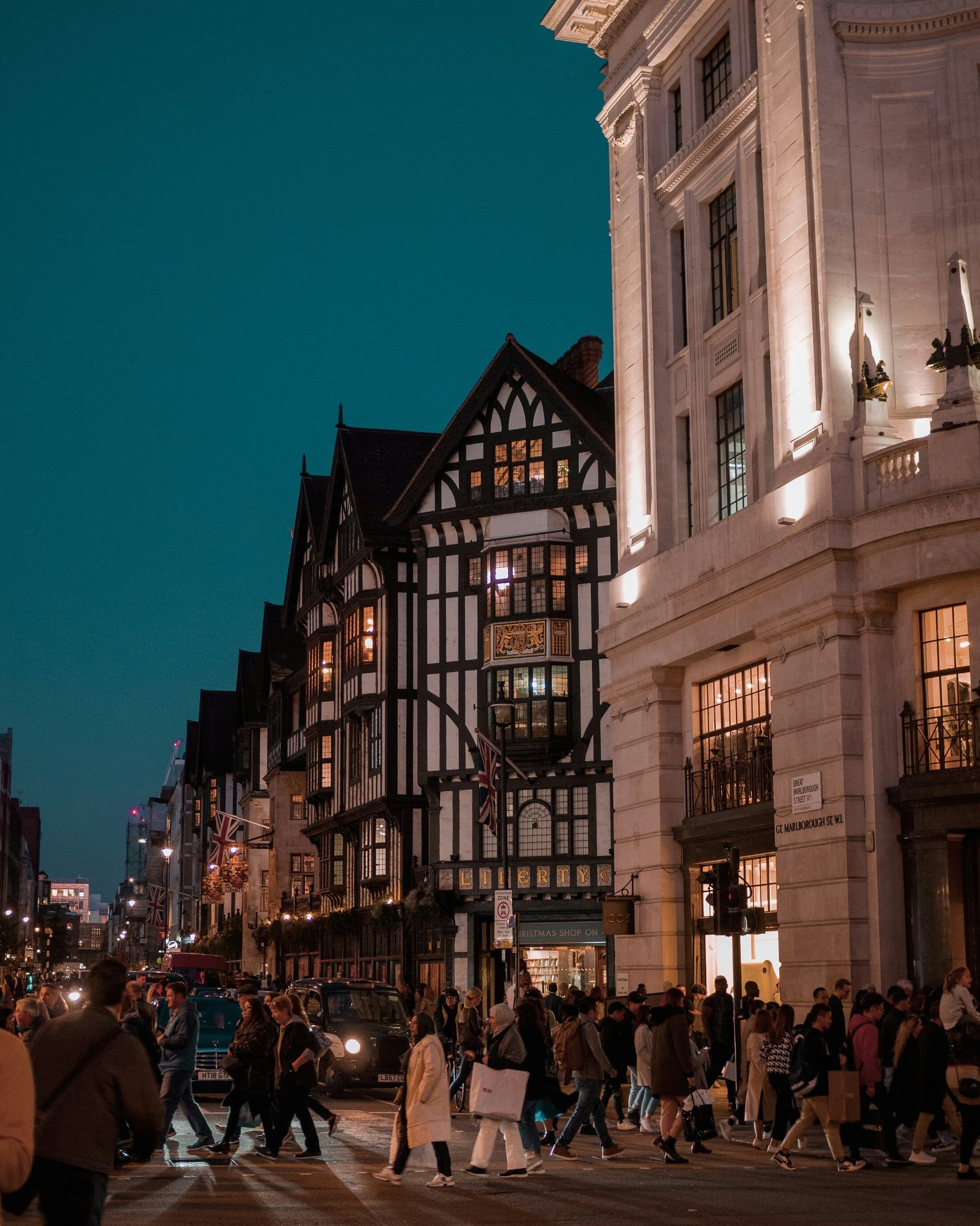 A London shopping street at dusk, where the buying is done